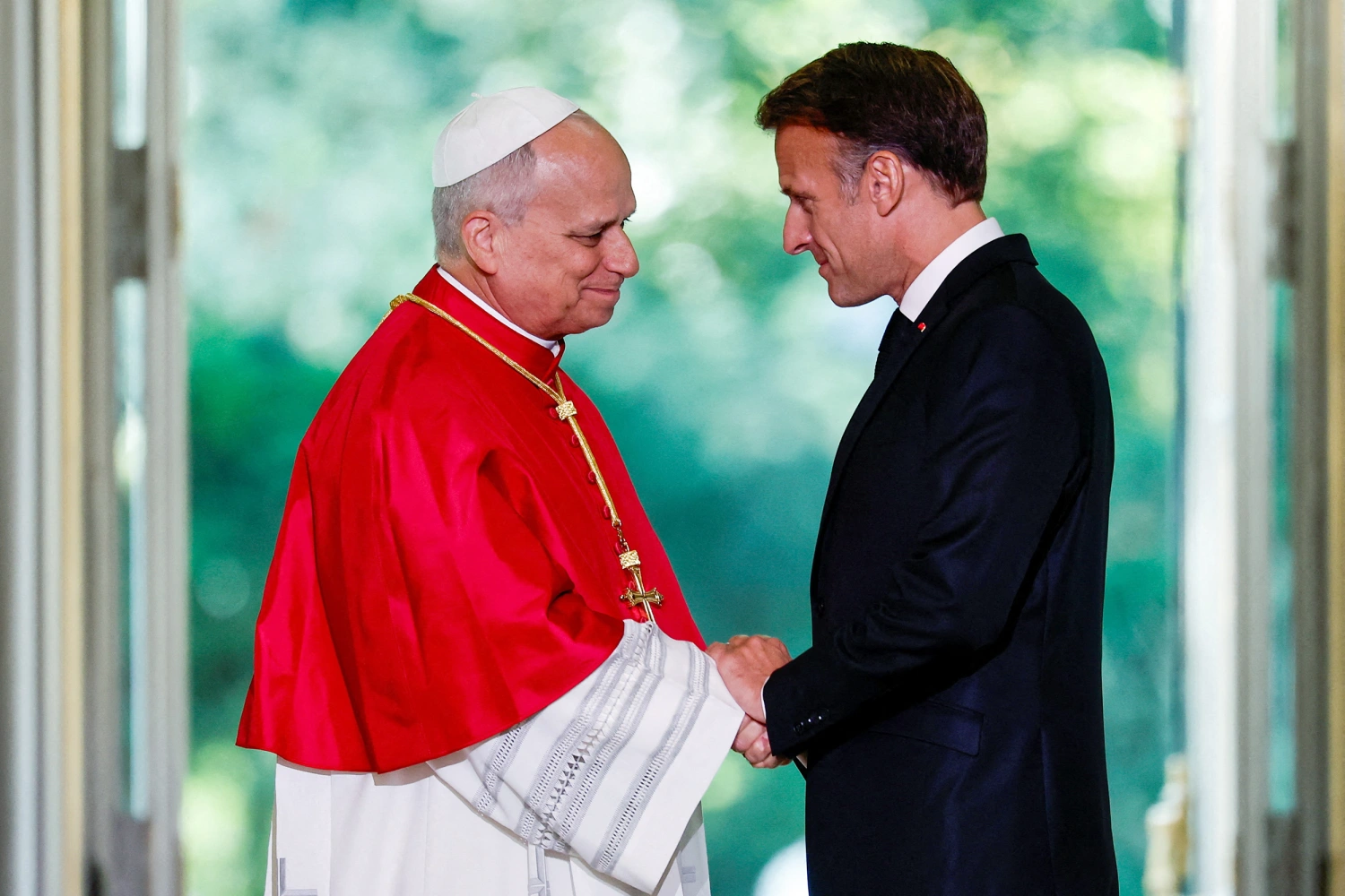 France's President Emmanuel Macron (R) and Pope Leo XIV (L) shake hands during a ceremony following their meeting at the Elysee Presidential Palace, in Paris on September 25, 2026 at the start of Pope's four days visit to France.