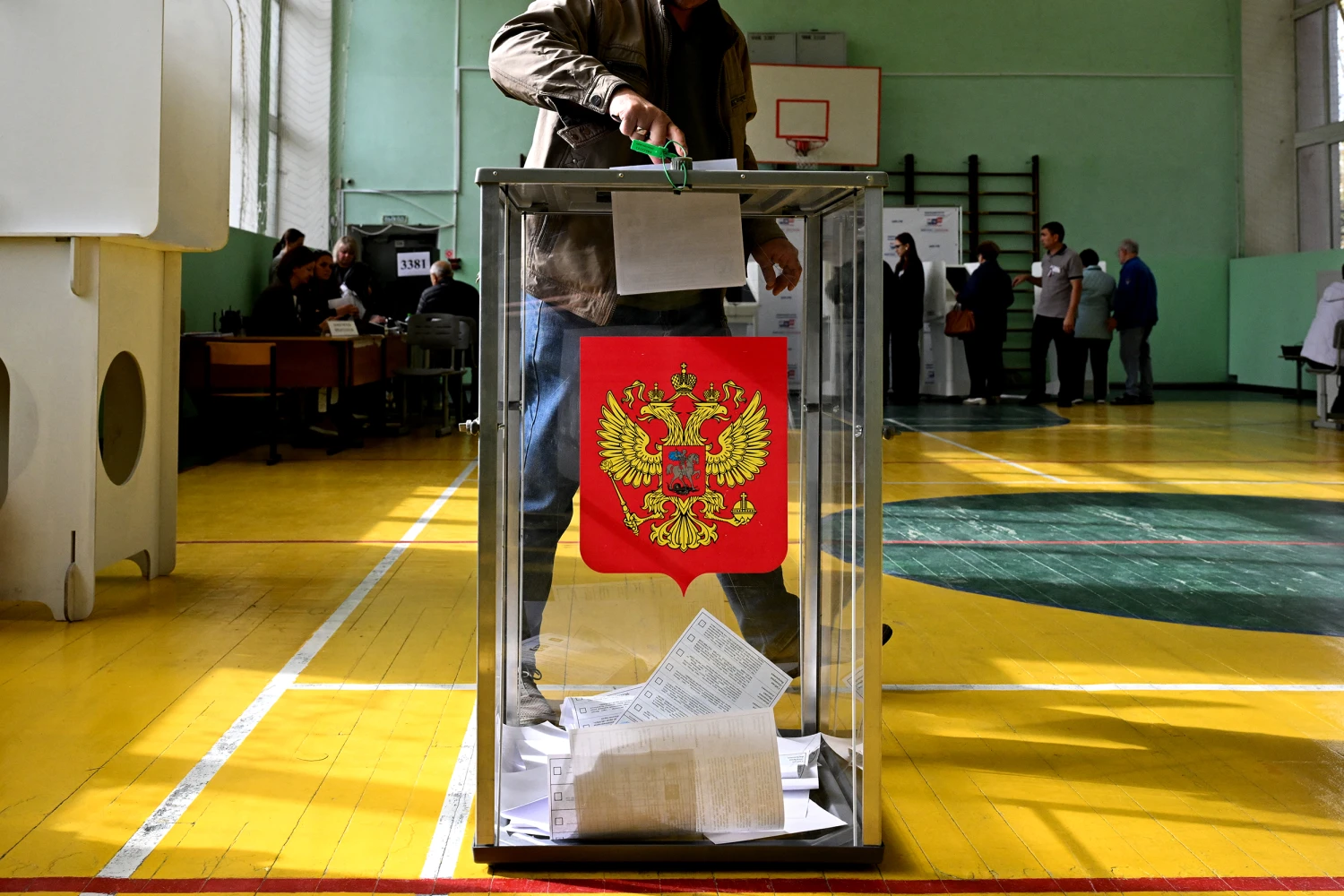 A man casts his ballot for Russia's parliamentary election at a polling station in the settlement of Shishkin Les in Moscow on September 19, 2026.