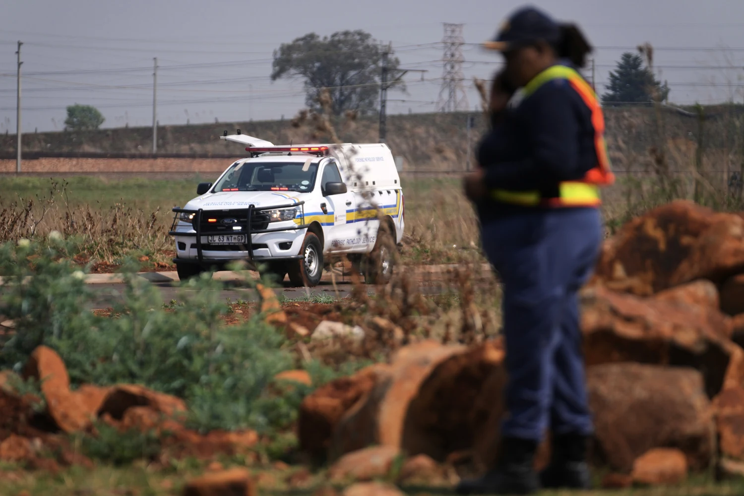 Forensic investigators work at the site where the body of a woman was discovered on the outskirts of Johannesburg, South Africa, Thursday, Sept. 17, 2026.