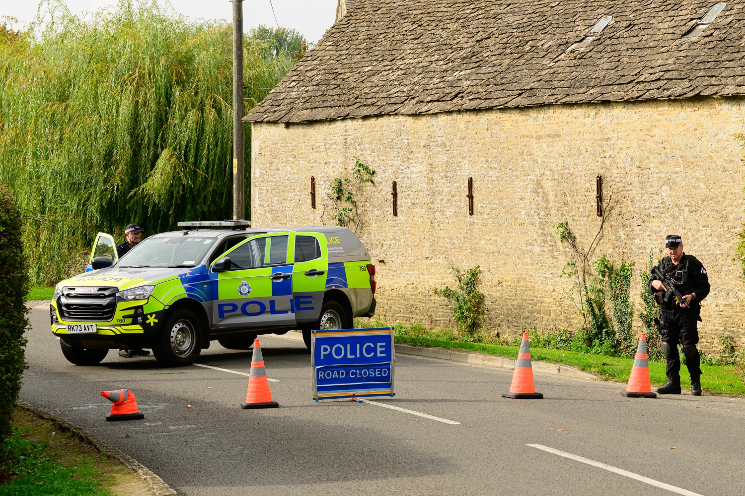 A police roadblock is in place on Sept. 27, 2026 after police declared a major incident and evacuated residents from their homes in Whelford, a village about one mile from RAF Fairford.