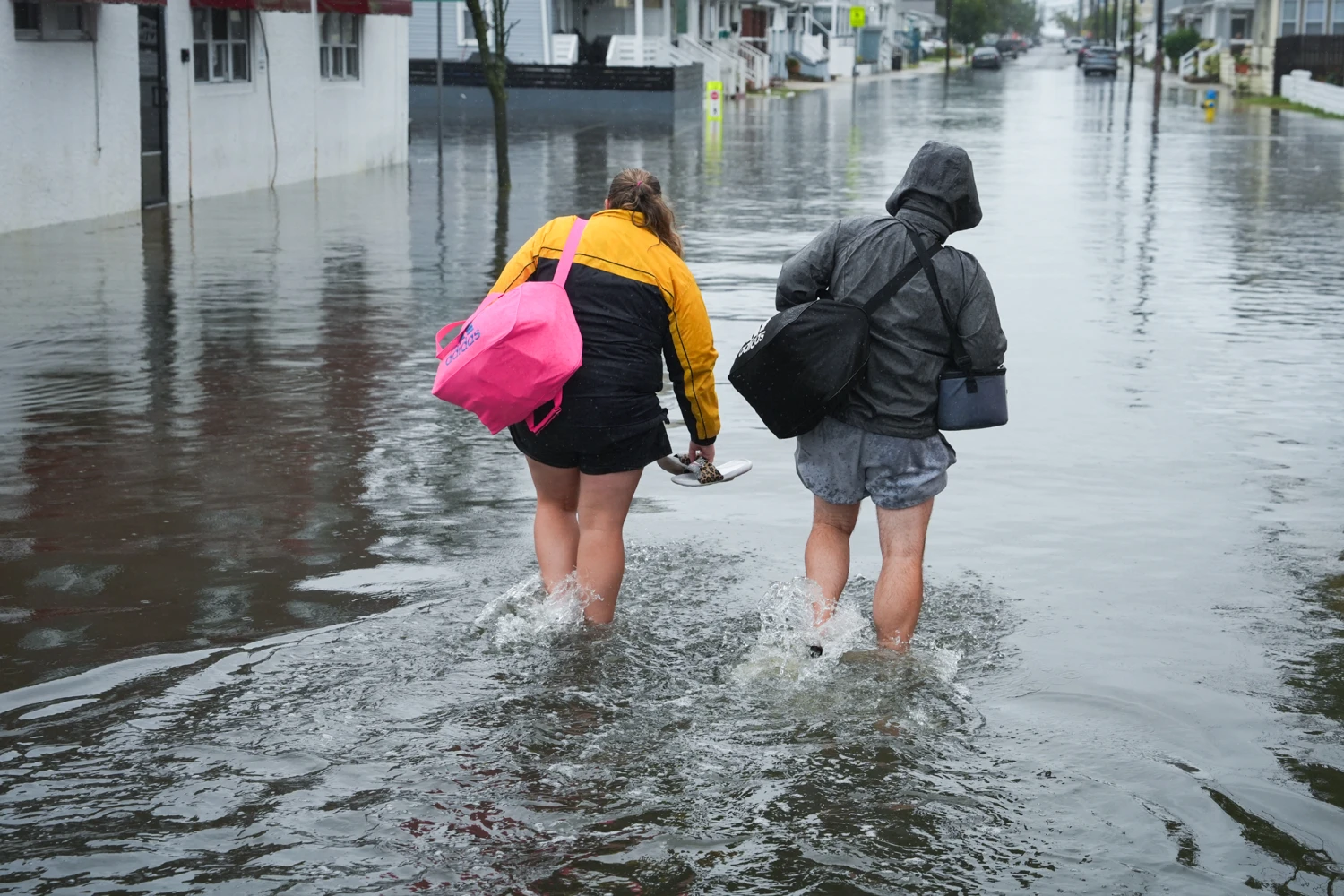 Mark F. And Carissa L. leave their flooded home with their belongings during a nor'easter storm on Sept. 27, 2026 in North Wildwood, New Jersey. A strong, early-season nor'easter has delivered a weekend of wind, soaking rain and massive waves to the Northeast.