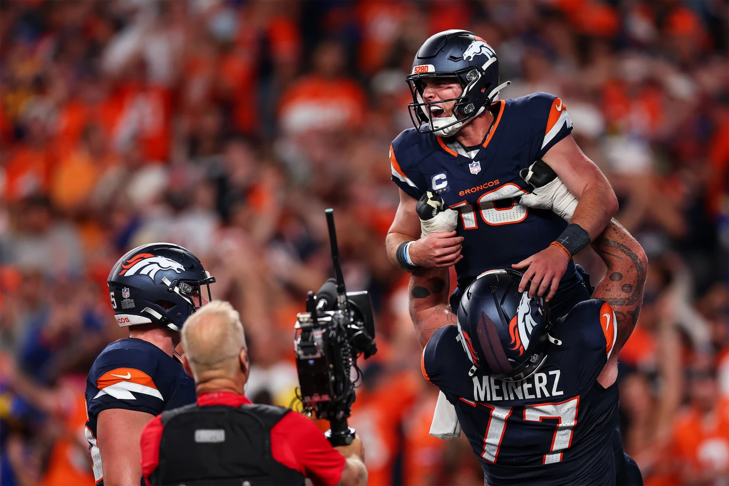 Bo Nix #10 of the Denver Broncos celebrates with teammates after scoring a touchdown during the fourth quarter of the game against the Los Angeles Rams at Empower Field at Mile High on September 27, 2026 in Denver, Colorado.
