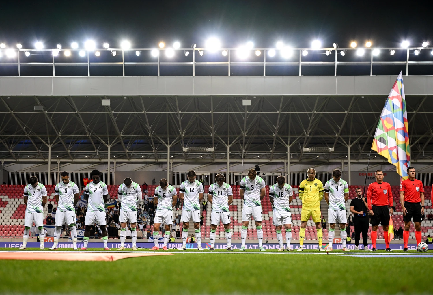 Debrecen , Hungary - 27 September 2026; The Republic of Ireland team, wearing black armbands in recognition for all the lives lost in the conflict in Gaza, bow their heads during the Israeli national anthem before the UEFA Nations League B match between Israel and the Republic of Ireland at Nagyerdei Stadion in Debrecen, Hungary.