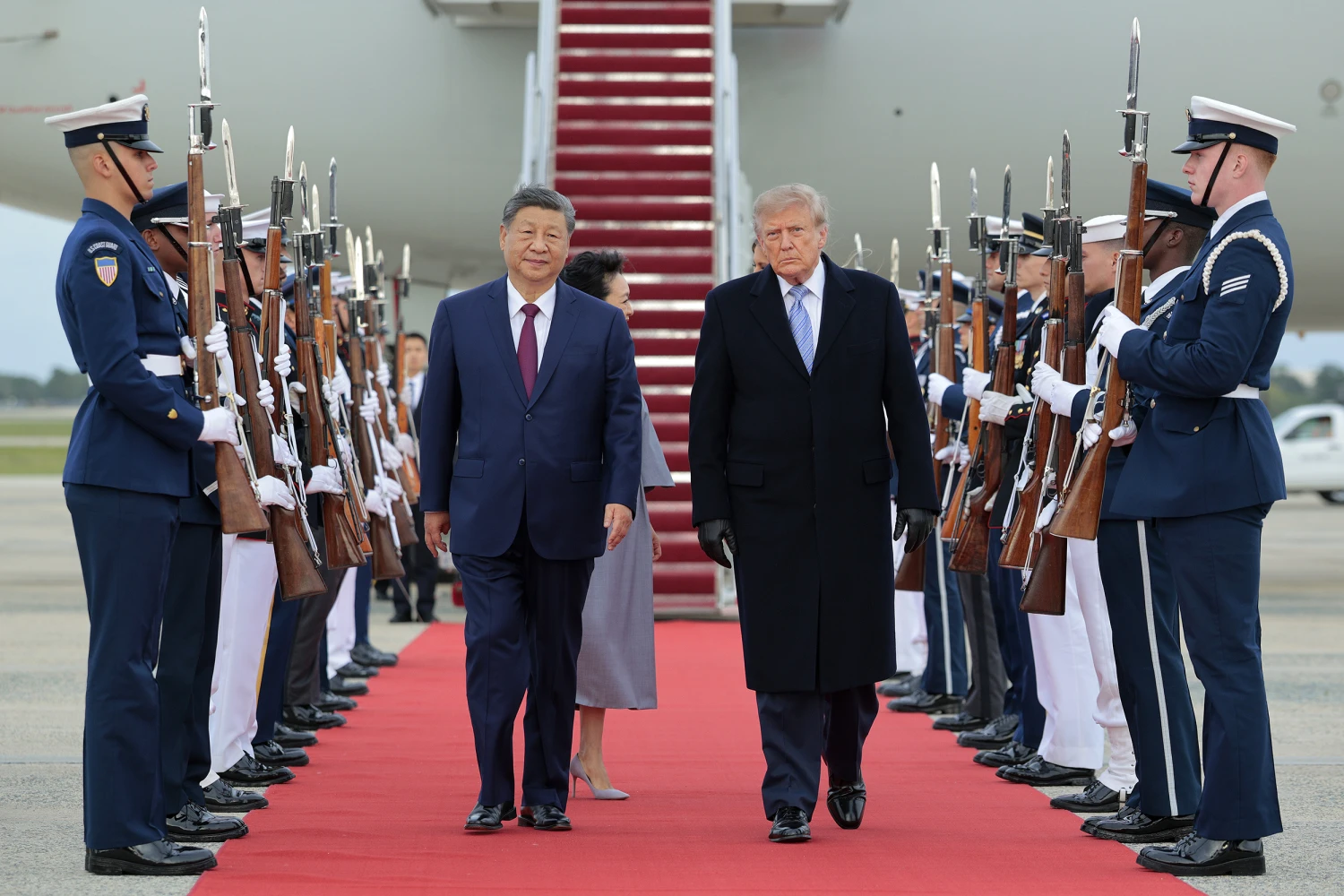 President Donald Trump (R) walks on a red carpet after greeting Chinese President Xi Jinping (L) during an arrival ceremony on September 23, 2026 at Joint Base Andrews, Maryland.