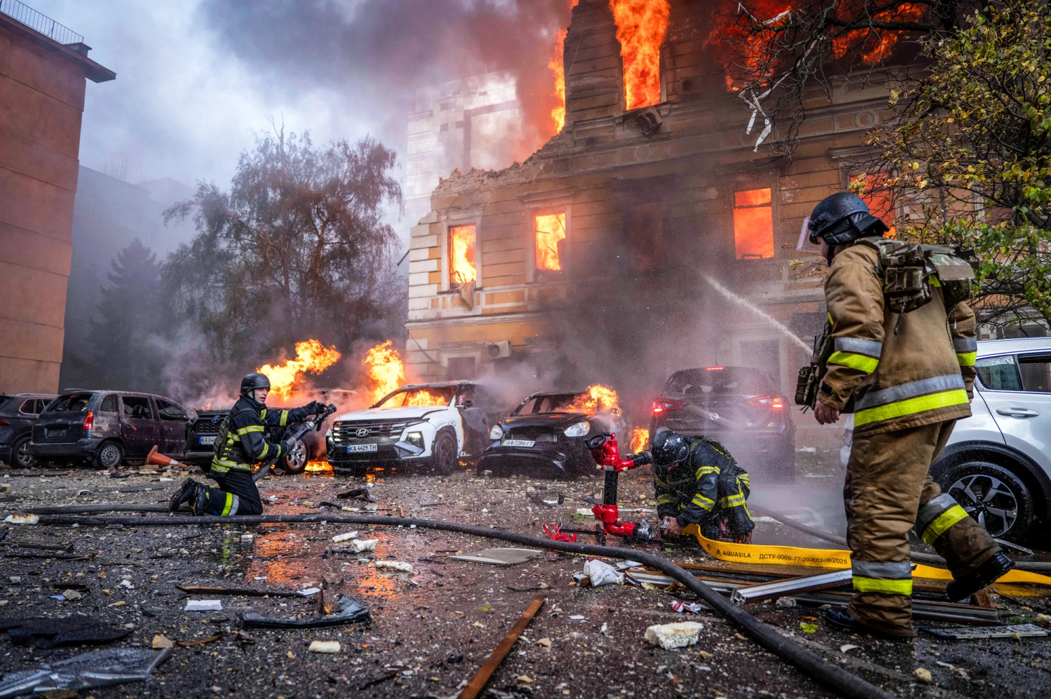 Rescue workers put out a fire at the National Academy of Sciences building damaged after a Russian drone strike in the center of Kyiv, Ukraine, on Sept. 28, 2026.