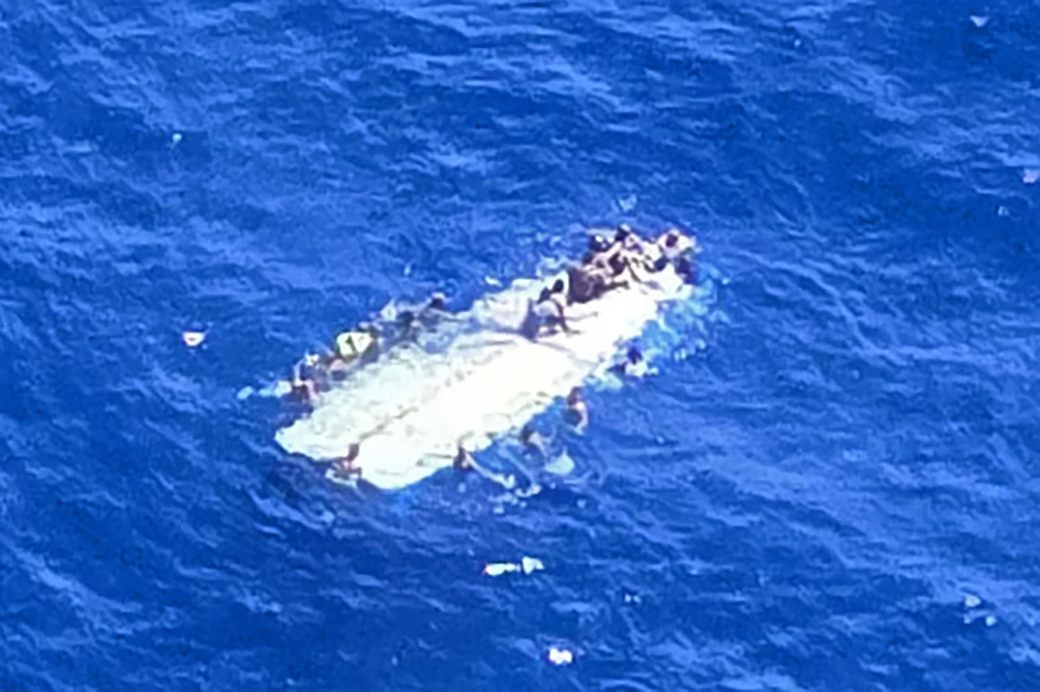 Coast Guard, partner agencies recover 2 deceased, rescue 40 off Mona Island; search continues
Survivors from a capsized makeshift vessel hold onto the hull to stay alive off Mona, Island, Puerto Rico, Sept. 28, 2026. The makeshift vessel reportedly capsized at approximately 11 p.m., Sunday, with an estimated 60 people aboard.