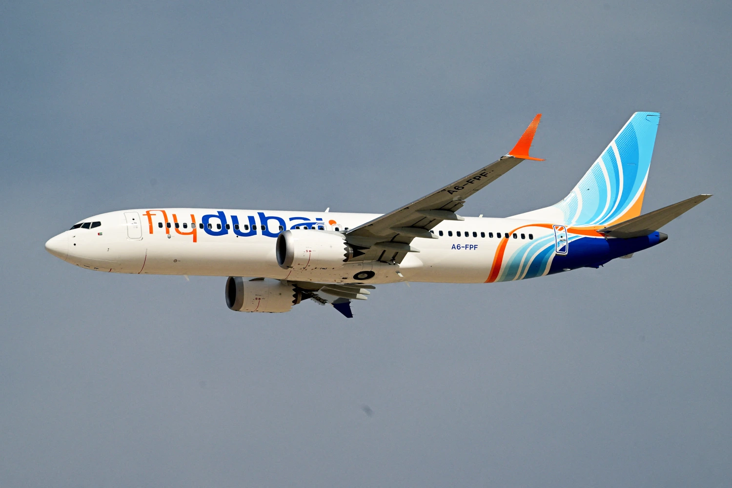A Flydubai Boeing 737 MAX 8 performs a display flight at Al-Maktoum International Airport during the Dubai Airshow 2025 in Dubai on November 17, 2025.
