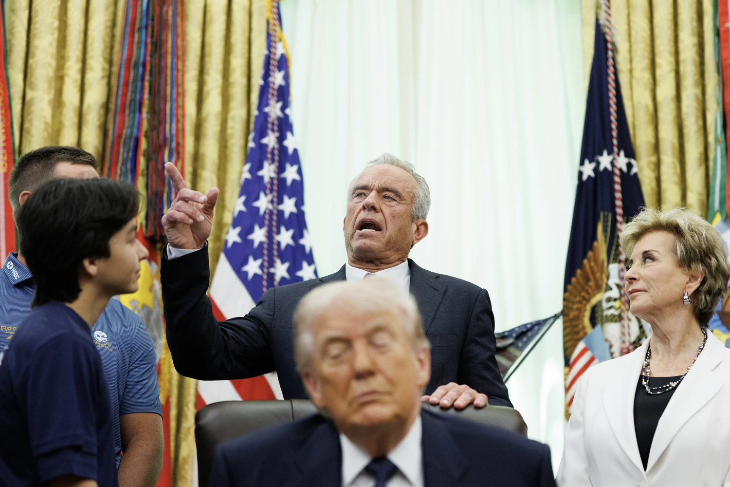 Secretary of Health and Human Service Robert F. Kennedy, Jr. speaks in the Oval Office as Education Secretary Linda McMahon looks on, in Washington on May 5, 2026. Trump is signing a memorandum that brings back the Presidential Fitness Test Award, part of a broader effort by the administration to revamp US public health policies.