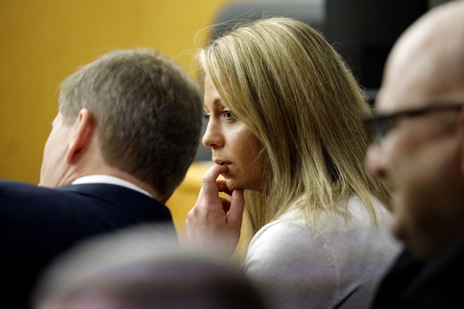 Fired Dallas police officer Amber Guyger listens to her attorney at court on Sept. 24, 2019.