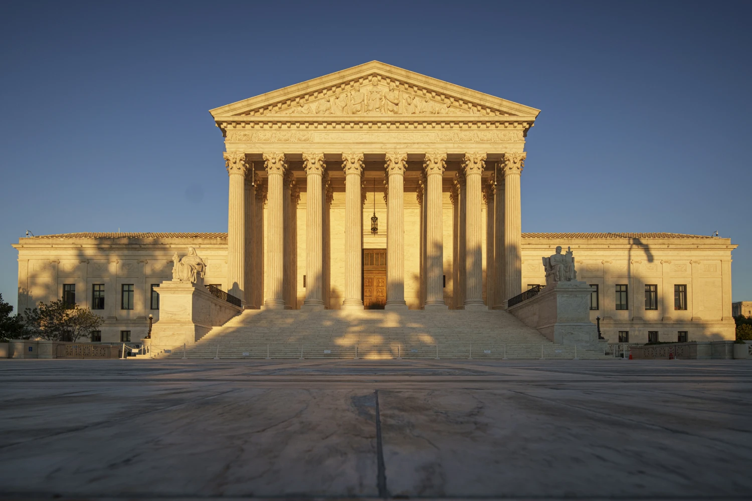 The setting sun casts a warm glow on the front of the U.S. Supreme Court building on September 14, 2026, in Washington, D.C.