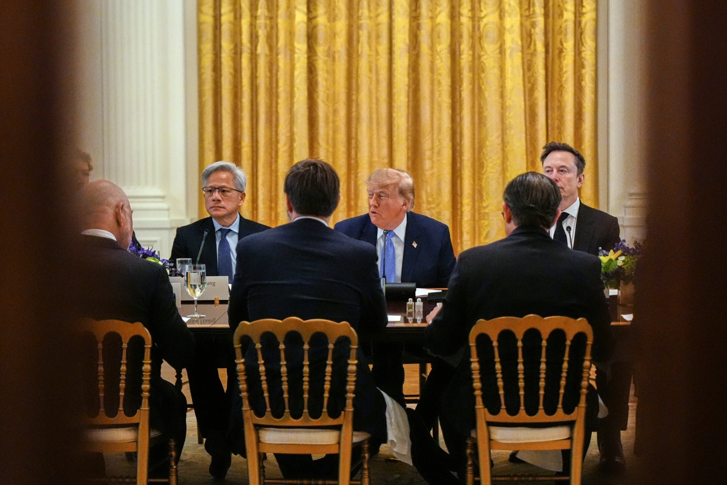 President Donald Trump in the East Room of the White House on Sept. 29, 2026, during a lunch meeting with top executives of AI firms, as NVIDIA CEO Jensen Huang, left, and Elon Musk listen.