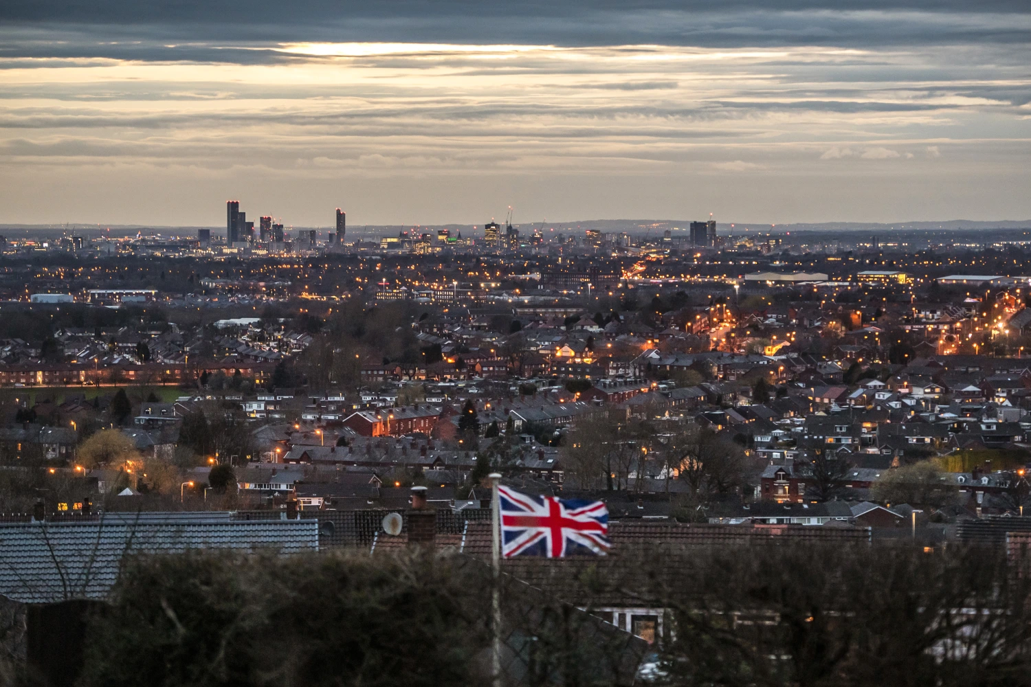 A Union flag flies in a garden overlooking Manchester on March 16, 2020 in Manchester, England.