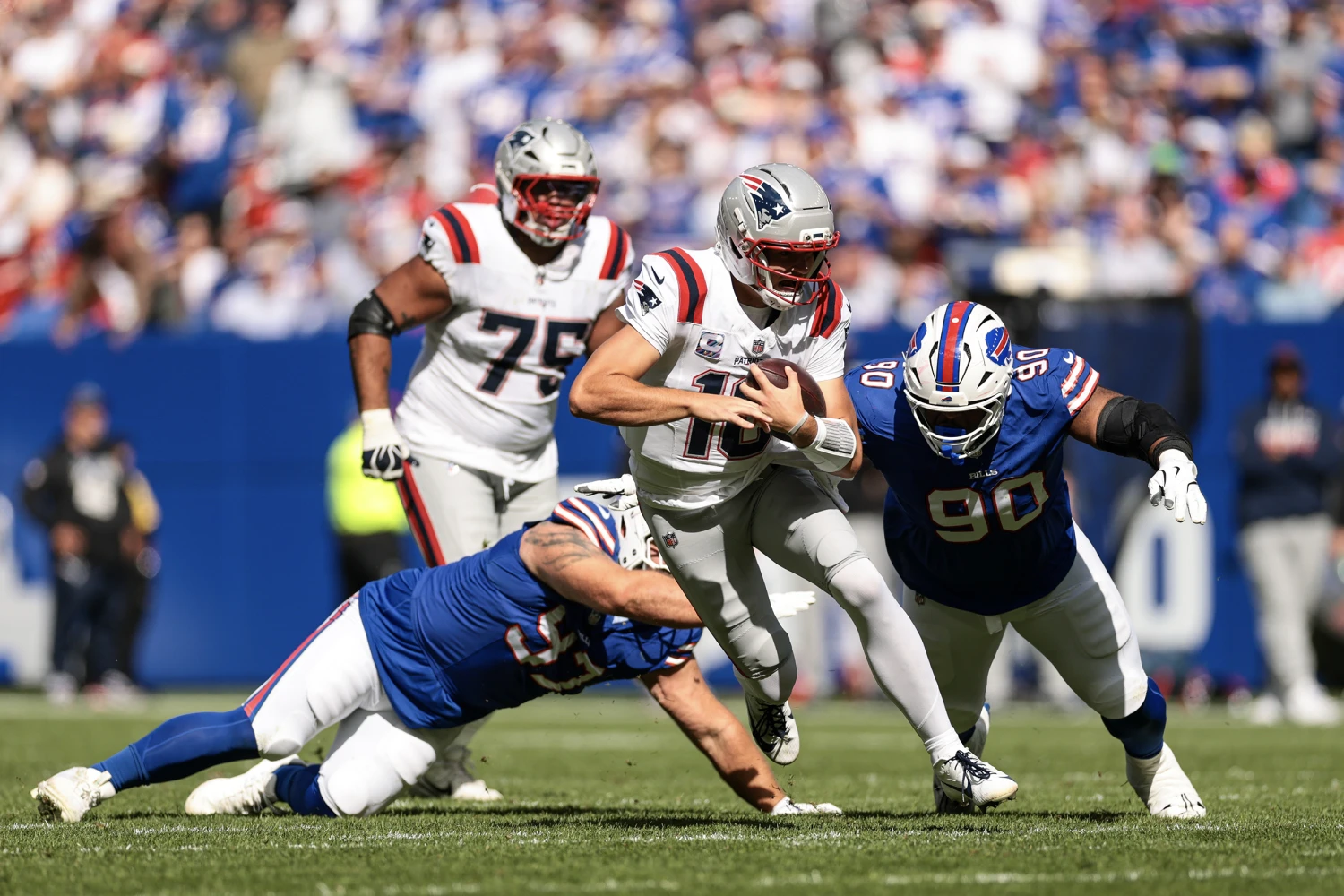 Drake Maye of the New England Patriots runs with the ball during the second quarter against the Buffalo Bills at Highmark Stadium on October 4, 2026 in Orchard Park, New York.