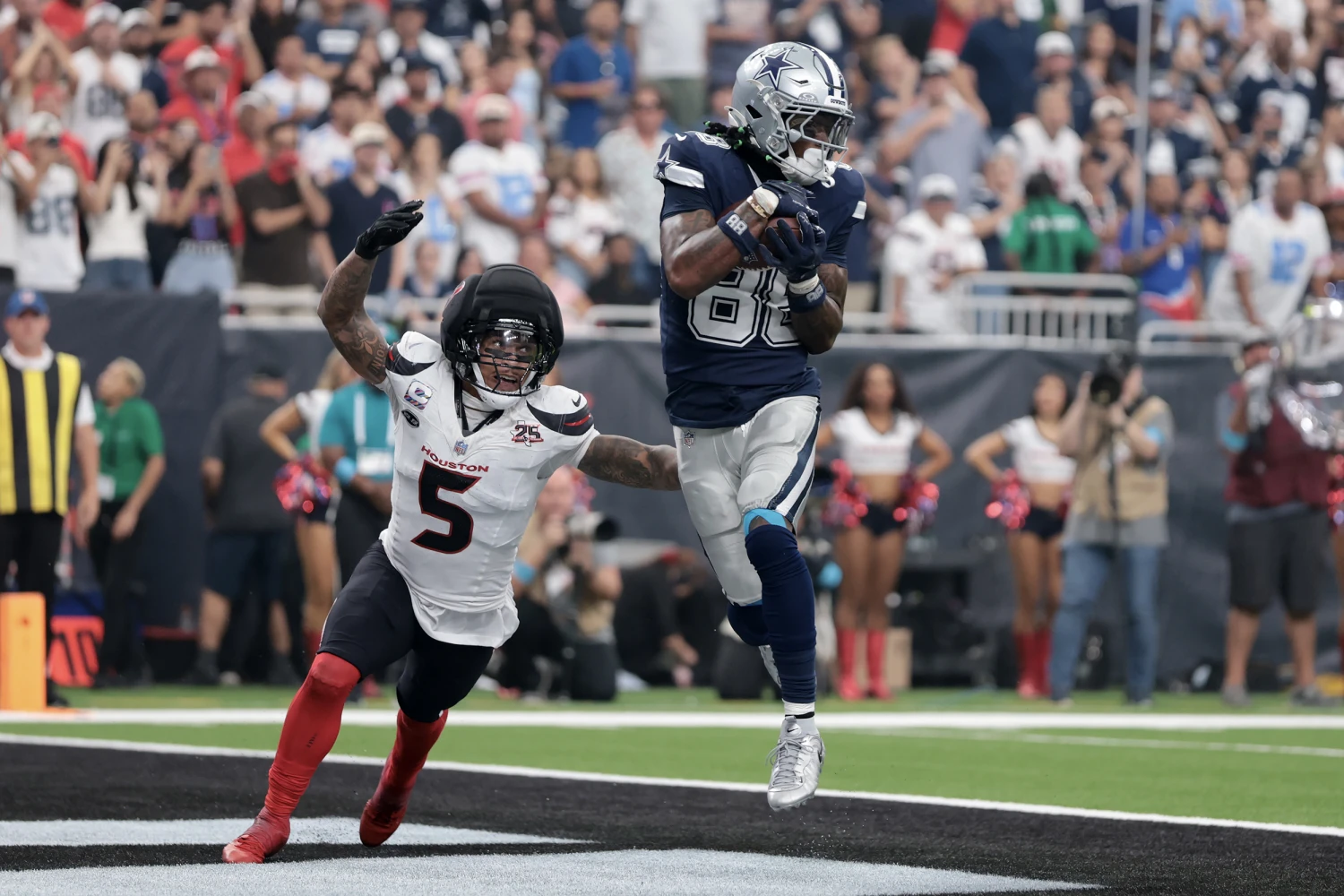 Ceedee Lamb of the Dallas Cowboys makes a catch for a touchdown against Jalen Pitre of the Houston Texans during the fourth quarter at NRG Stadium in Houston, on Oct. 4, 2026.