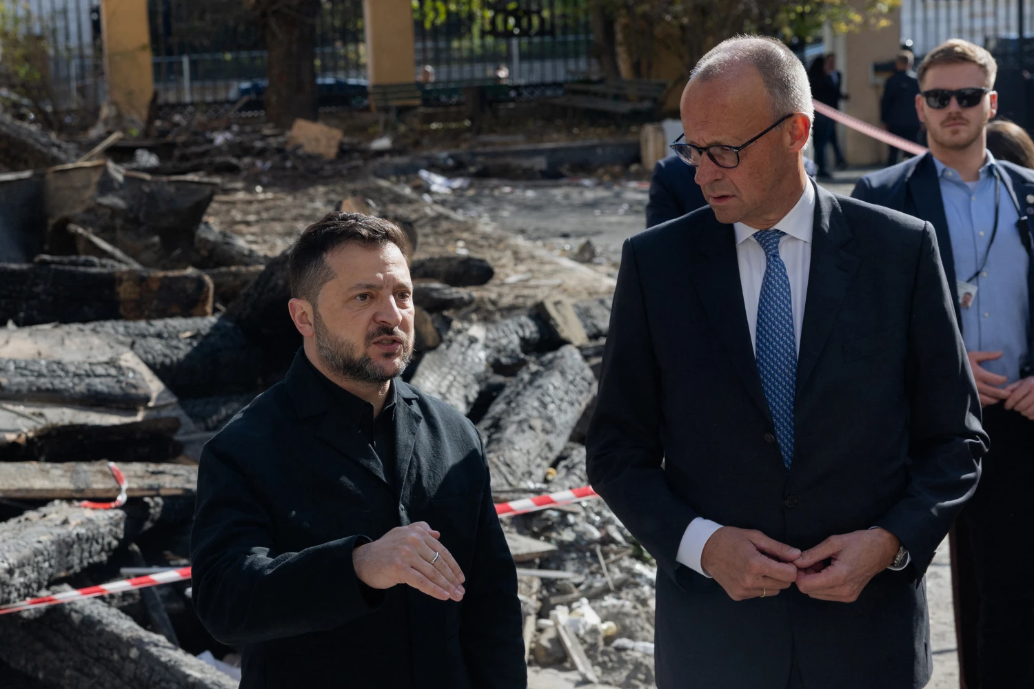Ukraine's President Volodymyr Zelenskyy and German Chancellor Friedrich Merz visit damaged building of the Ukrainian Academy of Science in Kyiv on Oct. 4, 2026.