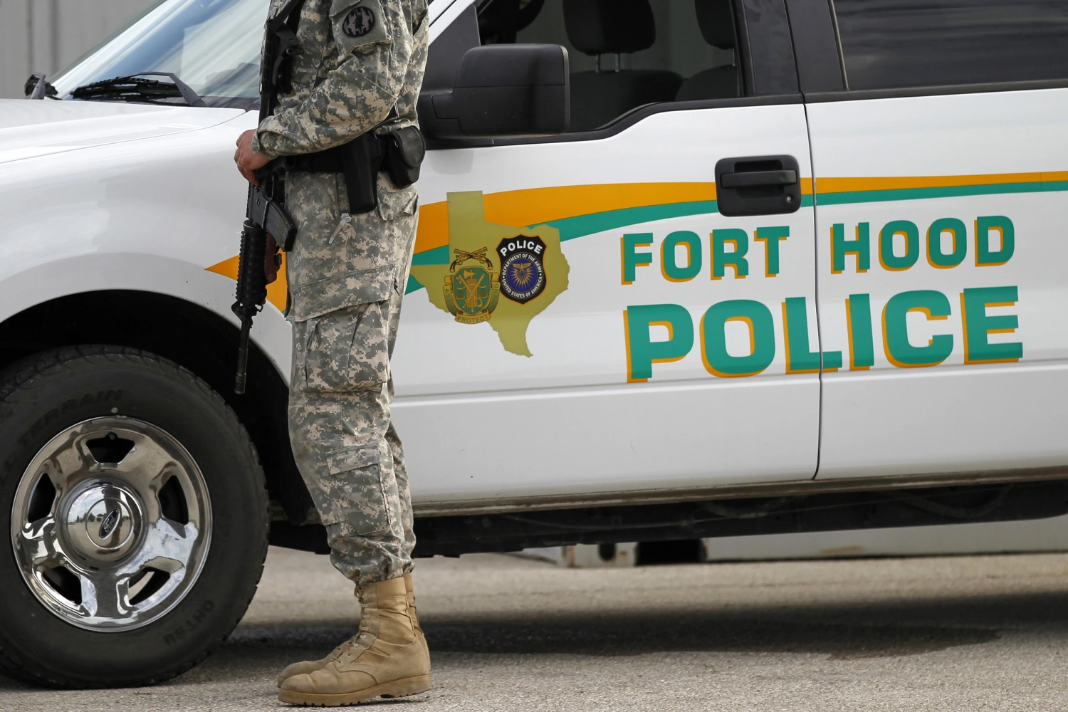 A U.S. Army police officer stands patrol outside the the Lawrence H. Williams Judicial Center as proceedings continue in the court martial of U.S. Army Maj. Nidal Malik Hasan, Wednesday, Aug. 21, 2013, in Fort Hood, Texas.