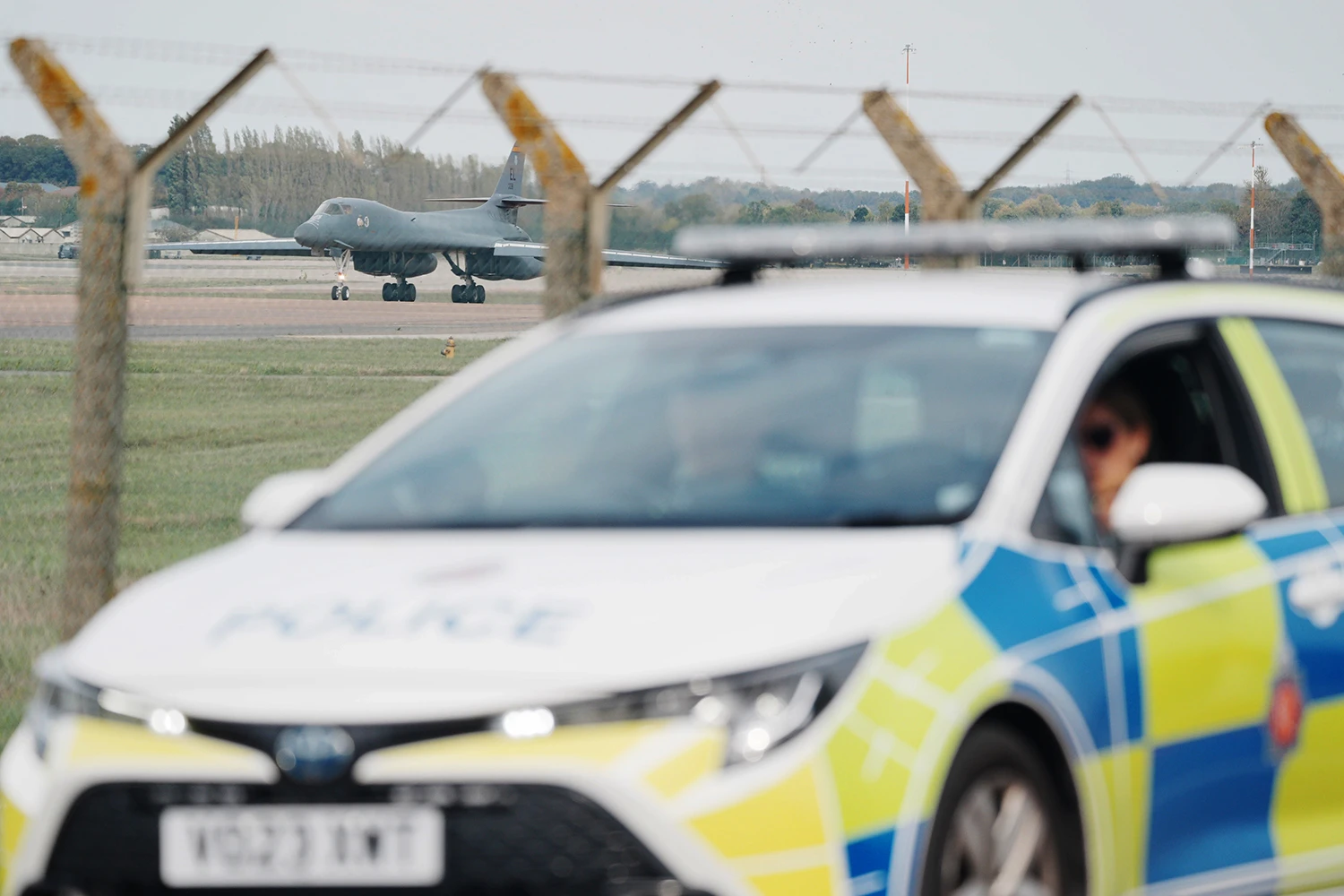 Police patrol the perimeter of RAF Fairford as a US Air Force Rockwell B-1 Lancer bomber lands on Sept. 28, 2026.