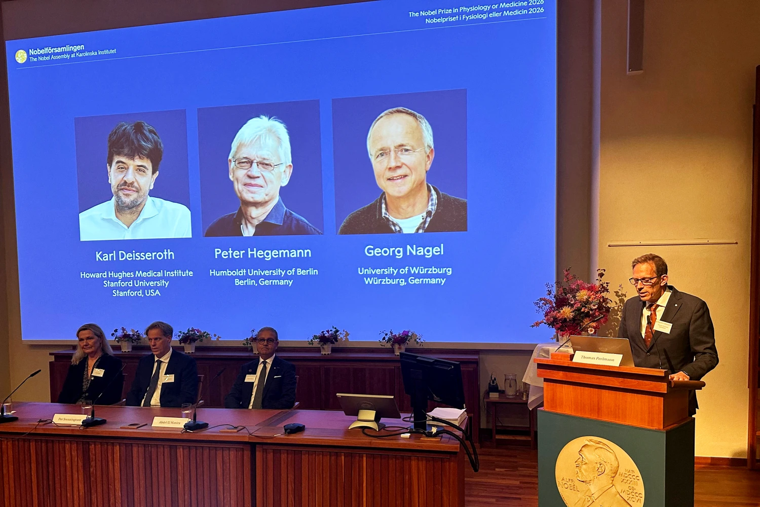 05 October 2026, Sweden, Stockholm: Anna Wedell (front, left to right), Per Svenningsson, Abdel El Manira, and Thomas Perlmann, secretary of the Nobel Assembly at the Karolinska Institute in Stockholm, at the announcement of the Nobel Prize laureates in Physiology or MedicineKarl Deisseroth, Peter Hegemann, and Georg Nagel, who are pictured on a displayat the Karolinska Institute. Photo: Steffen Trumpf/dpa (Photo by Steffen Trumpf/picture alliance via Getty Images)