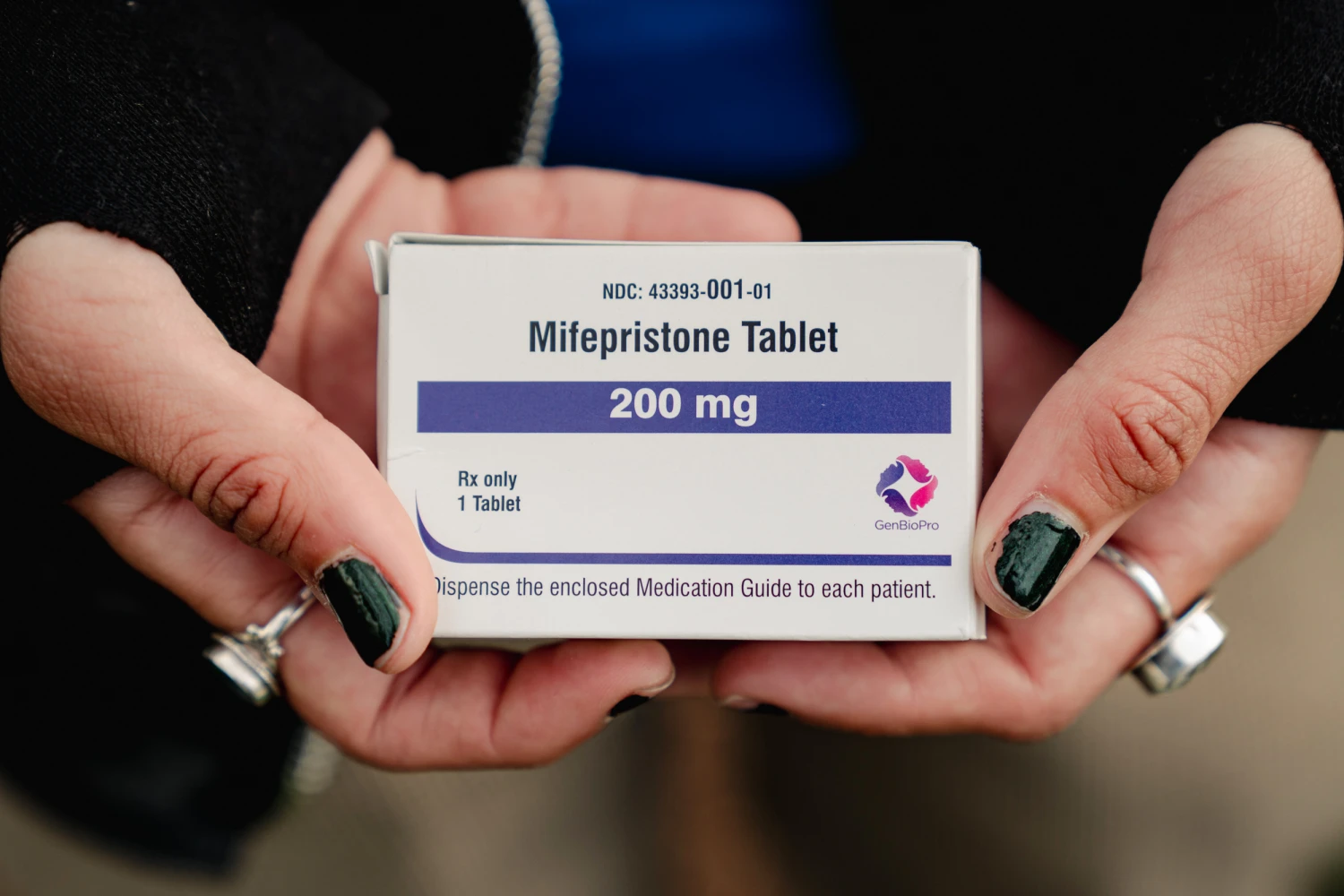 Trans man and abortion rights advocate Artemis Duffy of New England shows a box of mifepristone he is taking outside the Supreme Court in Washington, DC, on March 26, 2024.