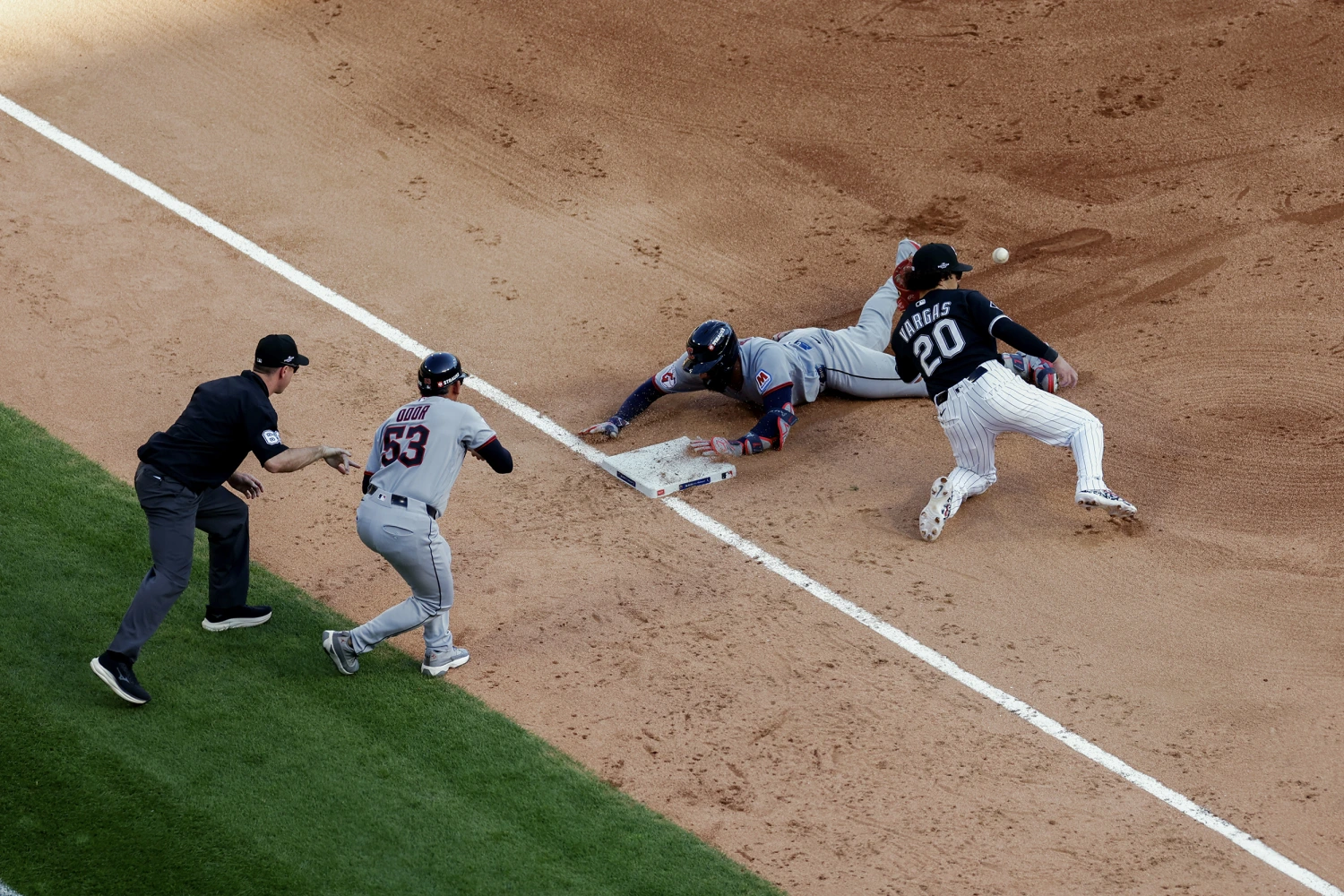 Jo Adell #7 of the Cleveland Guardians slides into third base with a triple in the third inning during Game Three of the American League Division Series presented by Booking.com between the Cleveland Guardians and the Chicago White Sox at Rate Field on Wednesday, October 7, 2026 in Chicago, Illinois.
