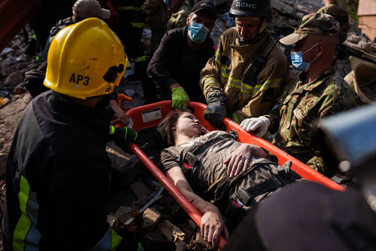 Locals and rescuers carry out an injured woman from a residential building destroyed in a Russian missile strike on Pryluky, Ukraine, on Oct. 7, 2026.
