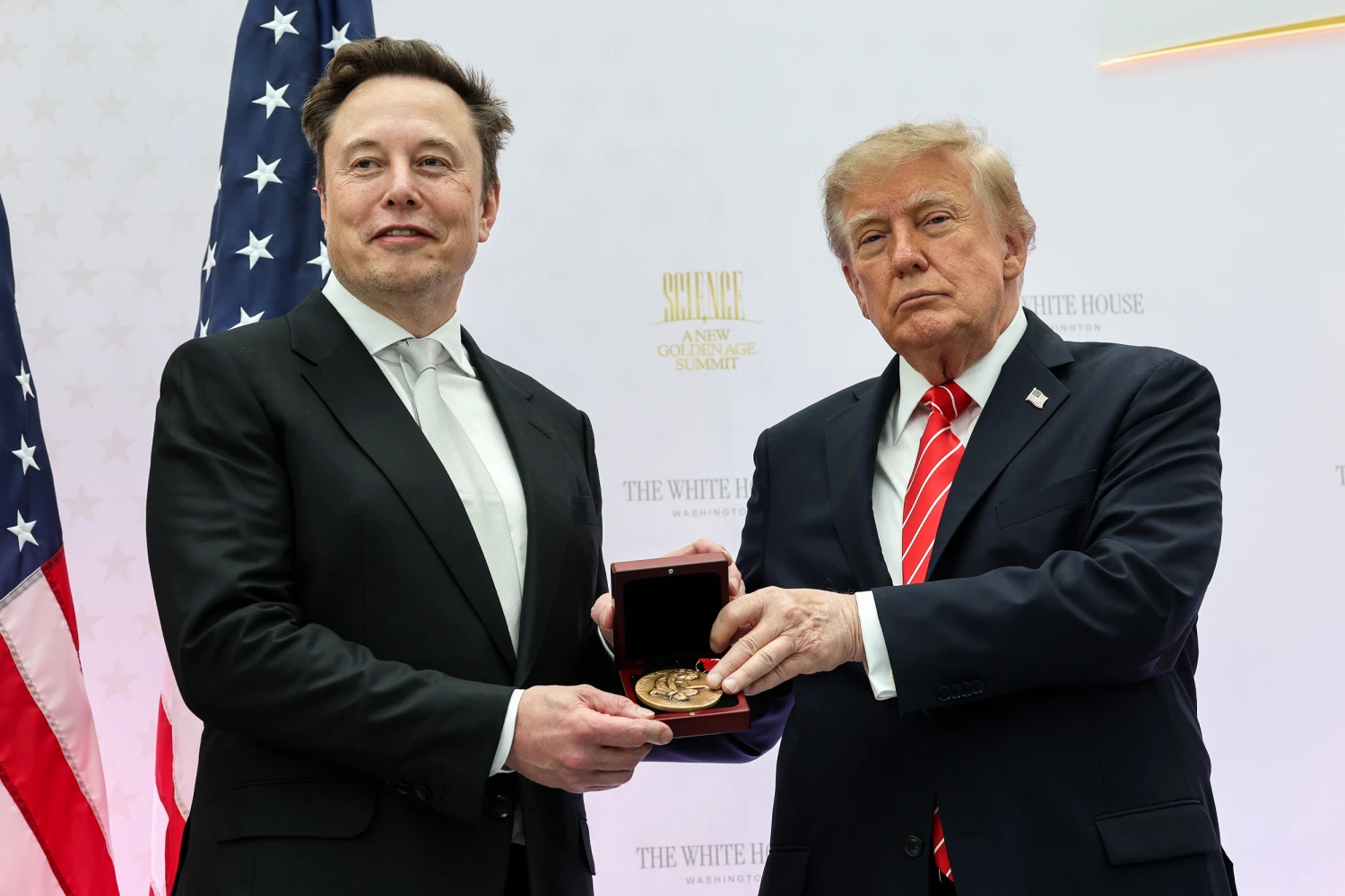 Tesla and SpaceX CEO Elon Musk (L) receives the National Medal of Science from U.S. President Donald Trump during the Golden Age of American Innovation Summit at the Institute of Peace on October 08, 2026 in Washington, D.C.