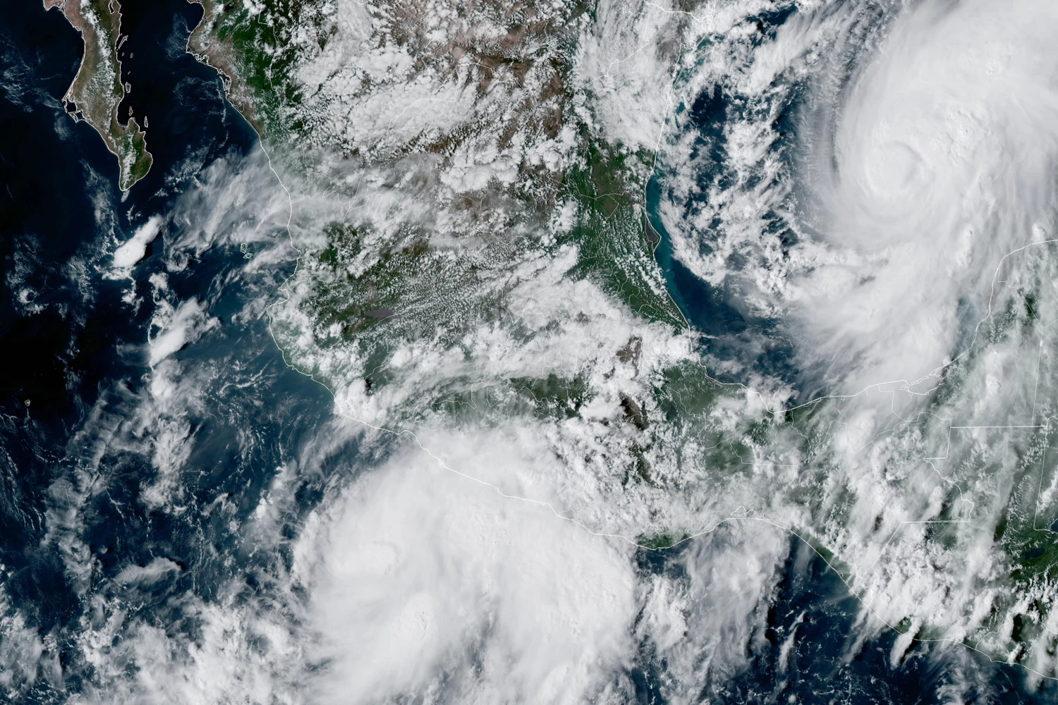 This GOES-19 GeoColor satellite image provided by the National Oceanic and Atmospheric Administration (NOAA) and taken at 4:57 p.m. EDT, Wednesday, Oct. 7, 2026, shows Tropical Storm Simon, bottom center, in the Pacific Ocean, off the southwestern coast of Mexico, and Tropical Storm Isaias, upper right, east of Mexico in the Gulf of Mexico.