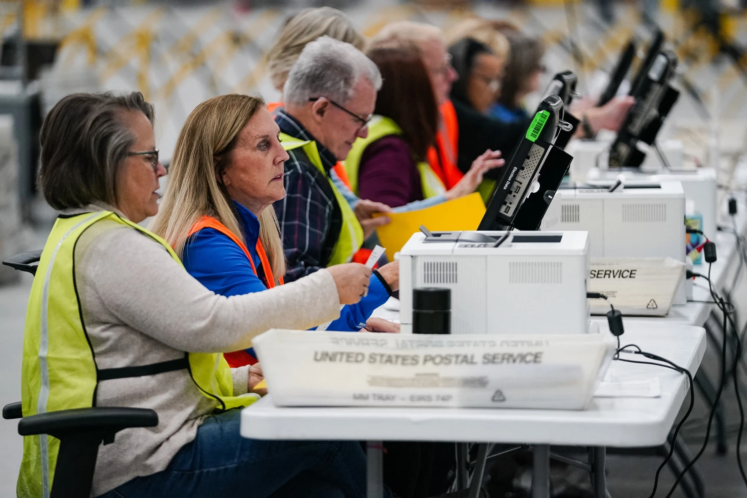 Fulton County elections workers process absentee ballots at the new Fulton County Elections Hub and Operations Center on November 4, 2024 in Union City, Georgia.