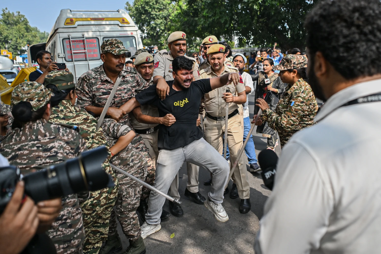 Police officers detain a protester during a demonstration on October 10, 2026 in New Delhi, India.