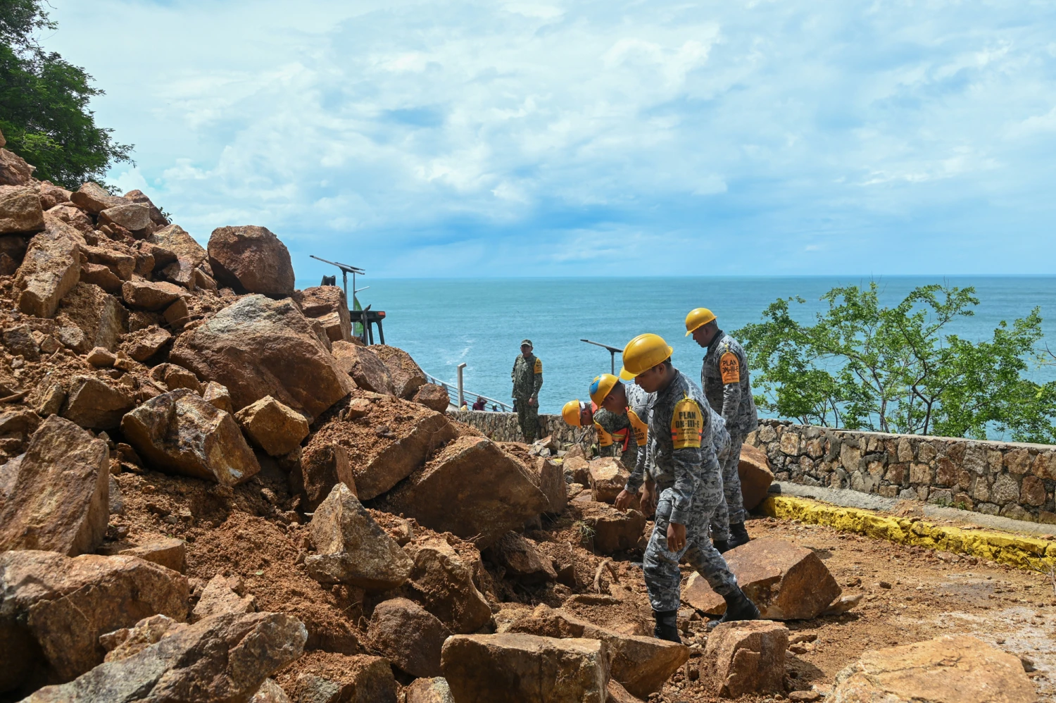 Members of the military and National Guard clear rubble from a landslide caused by heavy rains ahead of the arrival of Hurricane Simon in Acapulco, Guerrero state, Mexico, on Oct. 10, 2026.