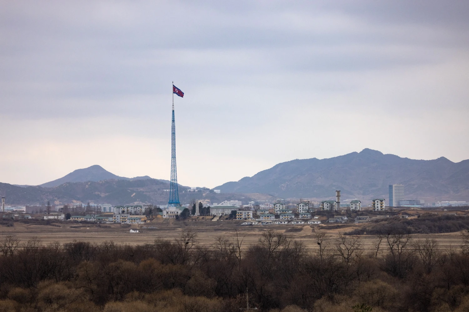 A North Korean flag flies above North Korea's Gijungdong village, from the truce village of Panmunjom in the Demilitarized Zone in Paju, South Korea, on March 3, 2023.