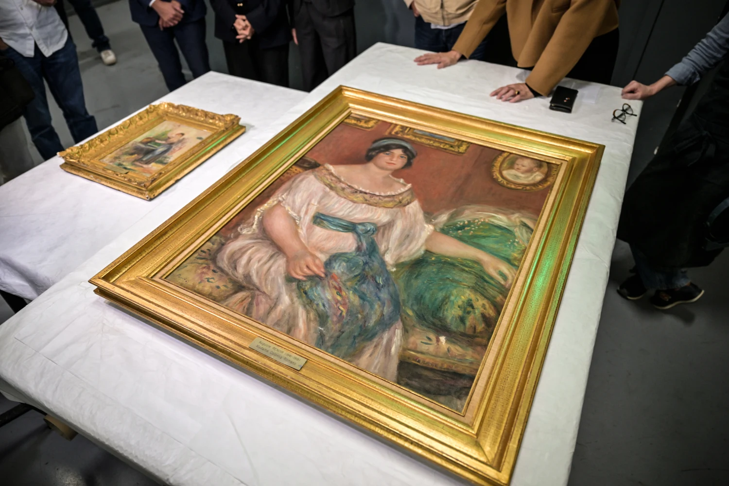 Recovered paintings "Portrait of Madame Colonna Romano", right, and "Young Woman at the Well," stolen from the Renoir Museum in Cagnes-sur-Mer are on display at the Interdisciplinary Centre for the Conservation and Restoration of Heritage in Marseille, France, on Oct. 12, 2026.