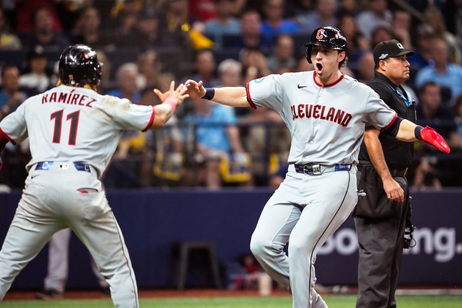Cleveland Guardians' José Ramírez and Chase DeLauter celebrate after scoring on a single by Nathaniel Lowe against the Tampa Bay Rays during the eighth inning in Game 1 of an American League Championship Series baseball game in St. Petersburg, Fla. on Oct. 12, 2026.