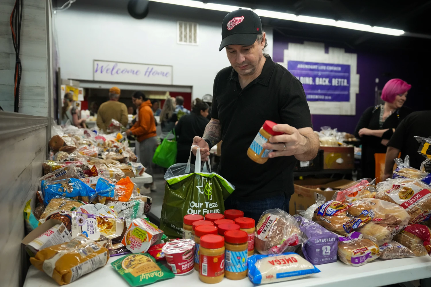 Residents at the Food For All food pantry at Abundant Life Church in Pflugerville, Texas in March, 2026.