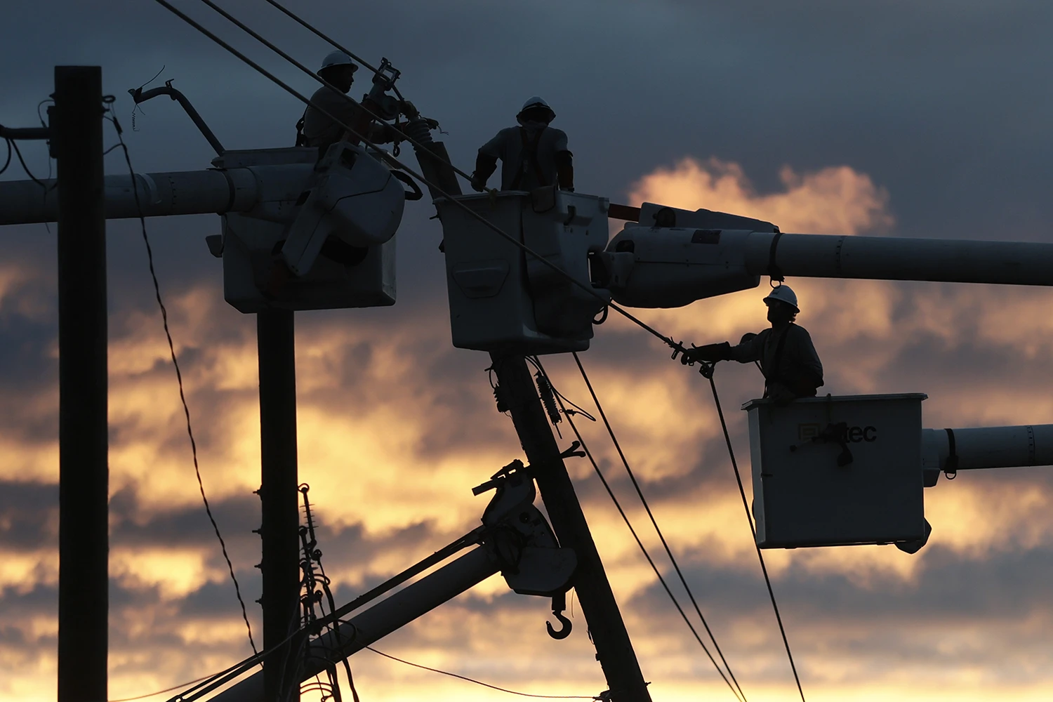 Linemen work to restore power in Milton, Fla., on Saturday. Thousands of people remain without power after Hurricane Isaias made landfall.
