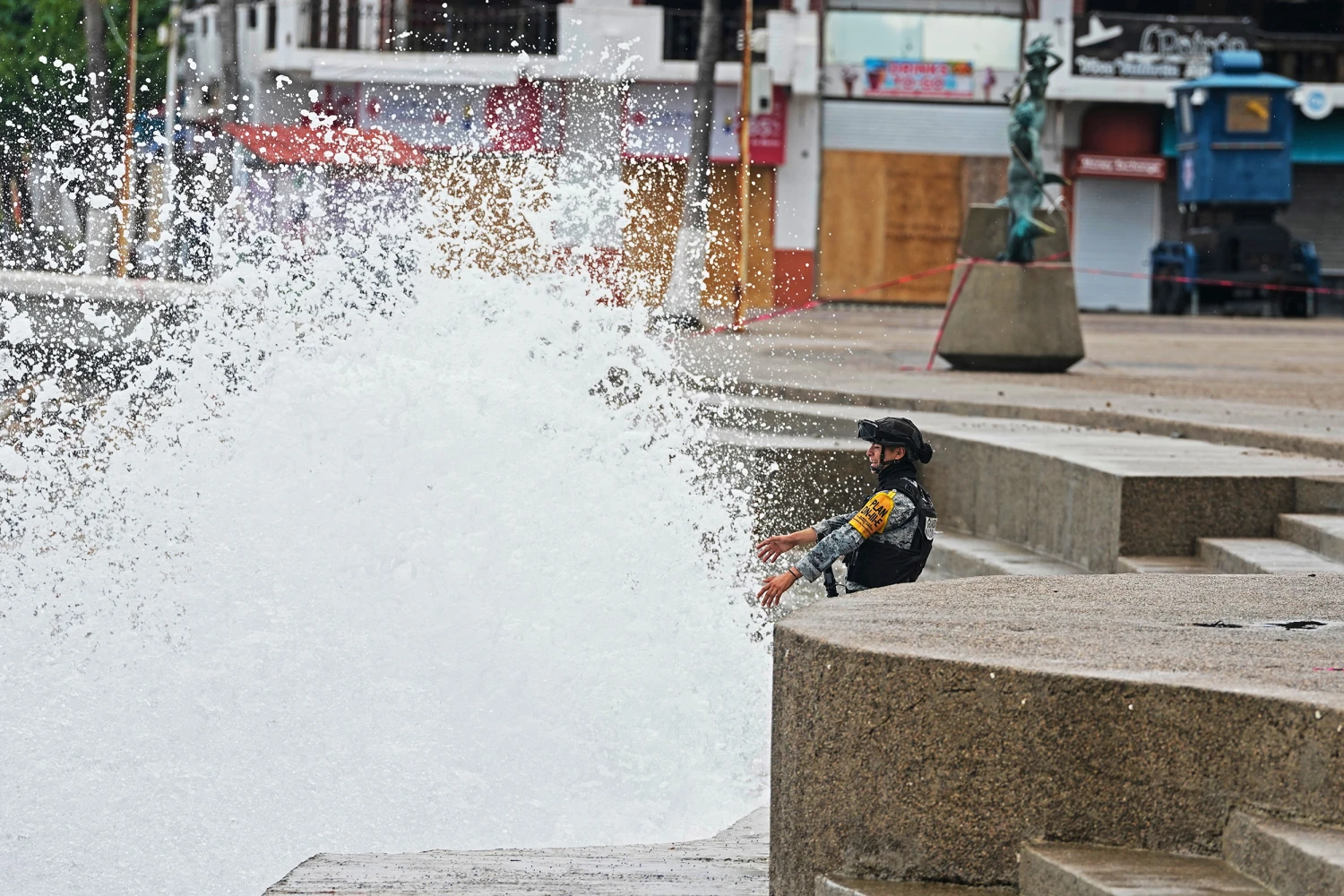 A National Guard on patrol faces the spray at the seawall as Hurricane Simon approaches Puerto Vallarta, Mexico, Sunday, Oct. 11, 2026.
