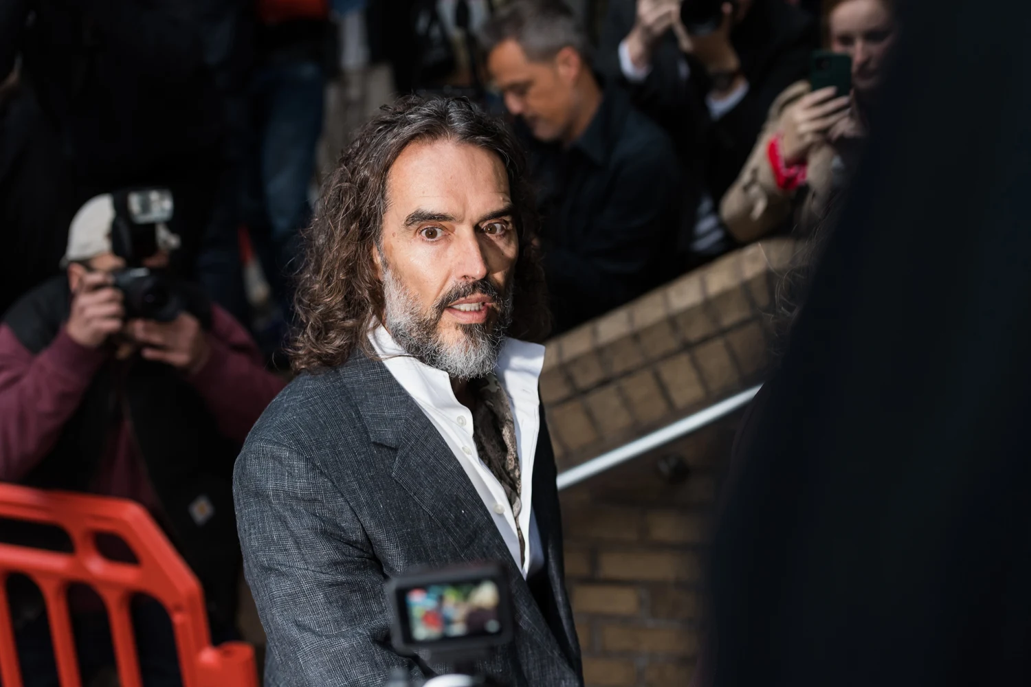 British comedian Russell Brand arrives at Southwark Crown Court to stand trial on charges of three counts of rape, three counts of sexual assault and one count of indecent assault, to all of which he pleaded not guilty and denies the allegations againt him, in London, United Kingdom on October 12, 2026.