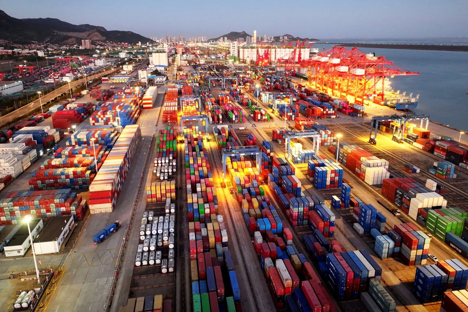 A cargo ship is docked at a berth, loading and unloading foreign trade containers at the container terminal of Lianyungang Port in Jiangsu Province, China, on the early morning of October 14, 2026.