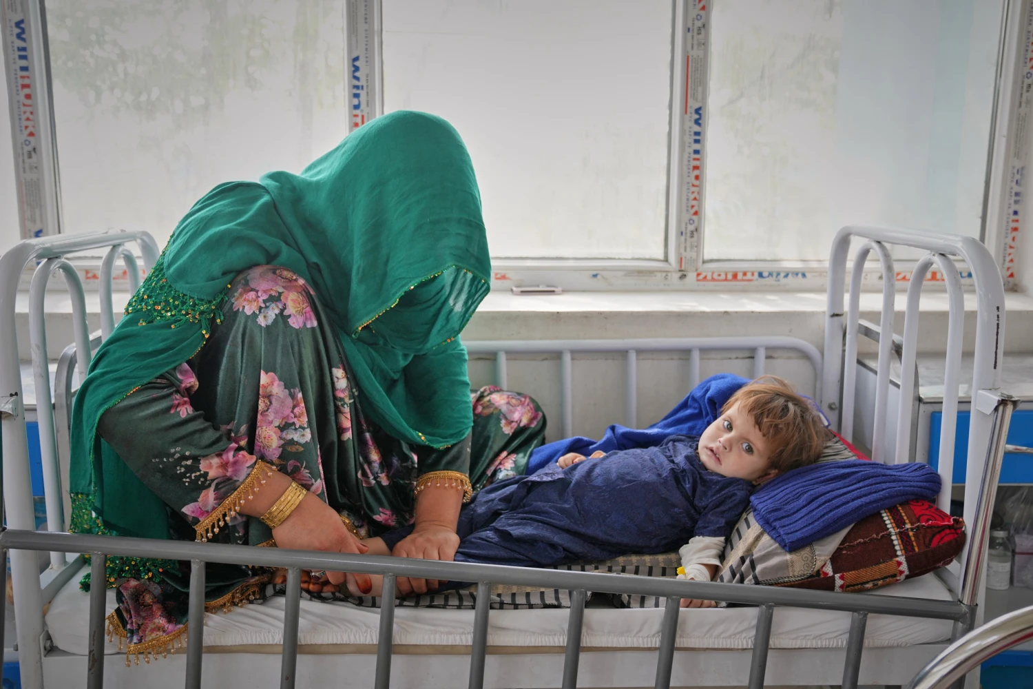 Malika tends to her daughter, Kalsoum, 3, in the malnutrition ward at Indira Gandhi children's hospital in Kabul, Afghanistan, on Oct. 12, 2026.