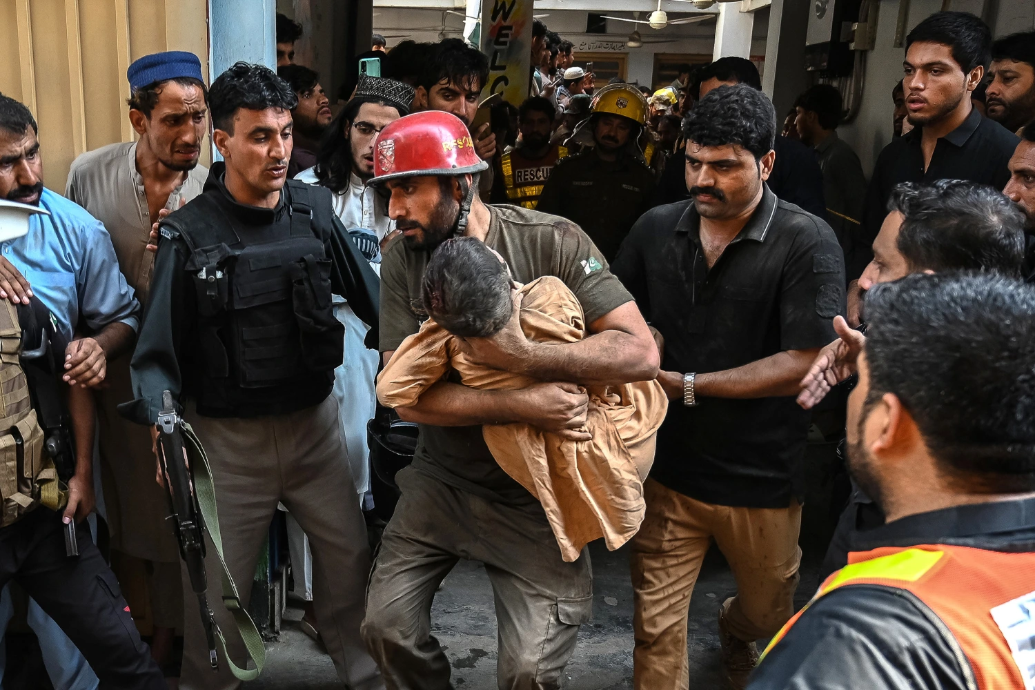 A rescuer carries a child during a search operation after a roof collapsed at a school in Peshawar on October 15, 2026. Twenty-seven pupils and a teacher were killed on October 15 after a roof collapsed at a school in the northwest Pakistani city of Peshawar, a hospital official said.