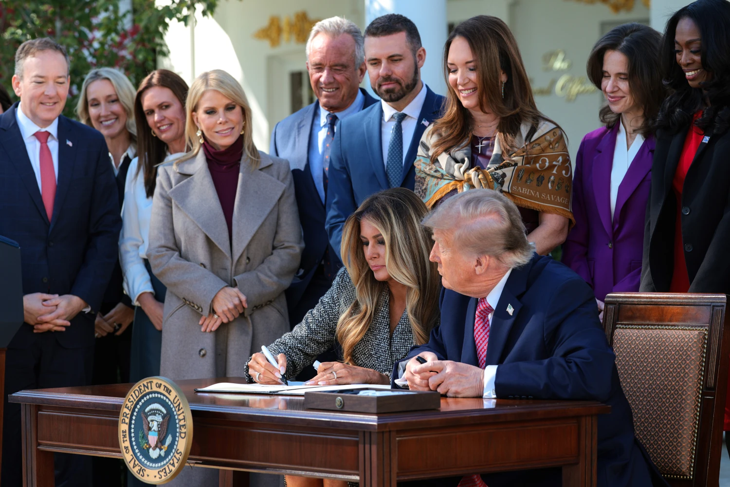 President Donald Trump and first lady Melania Trump sign an executive order in the Rose Garden of the White House on Oct. 19, 2026.