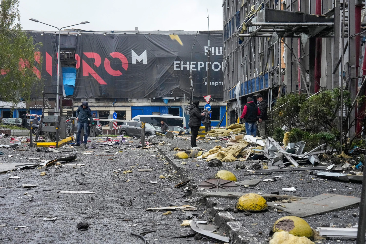 People look at damaged office center after a Russian missile attack in central Kyiv, Ukraine, Monday, Oct. 19, 2026.