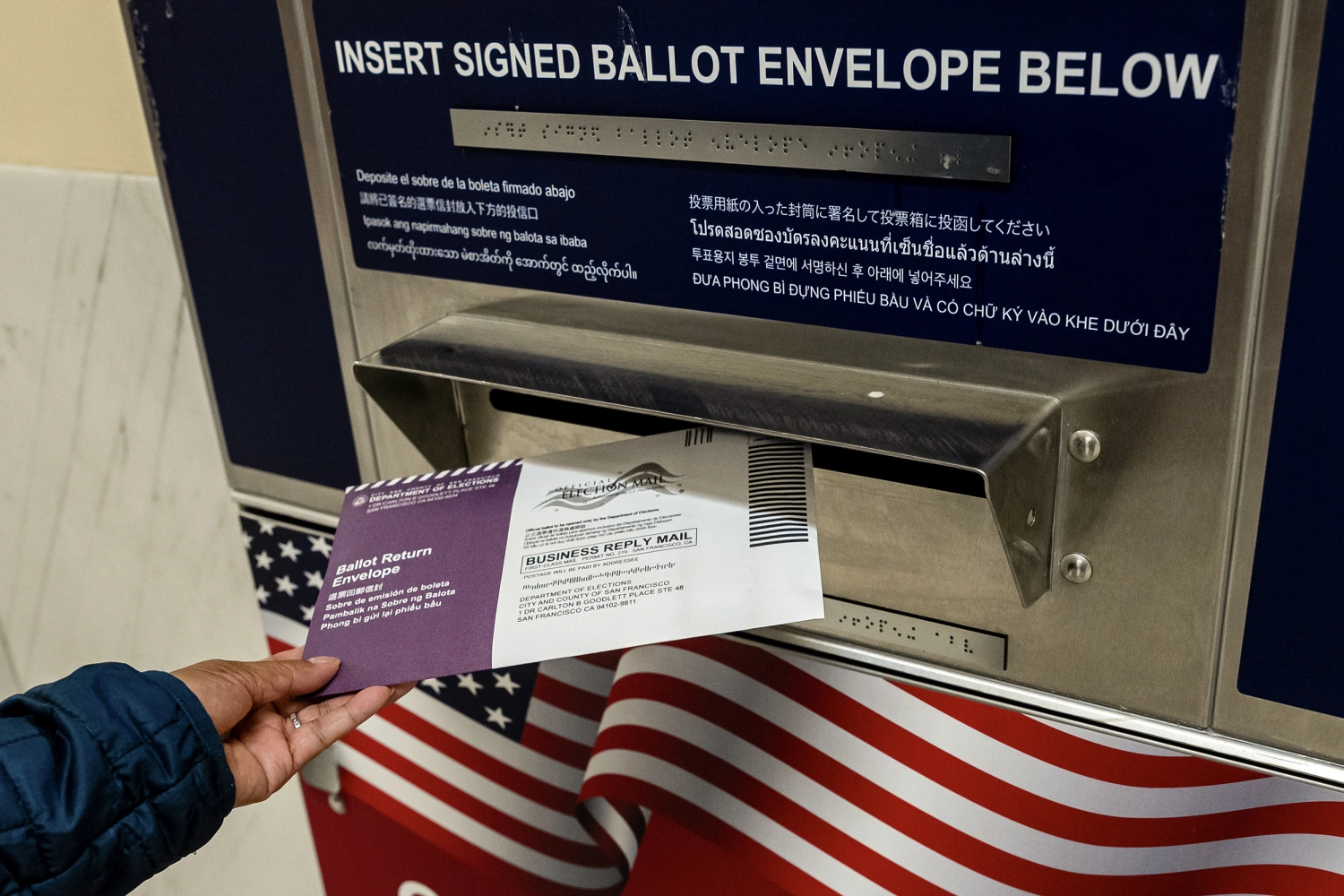 A voter drops their ballot into an official ballot dropbox during early voting ahead of the midterm election at a polling location inside City Hall in San Francisco, California, US, on Wednesday, Oct. 21, 2026.