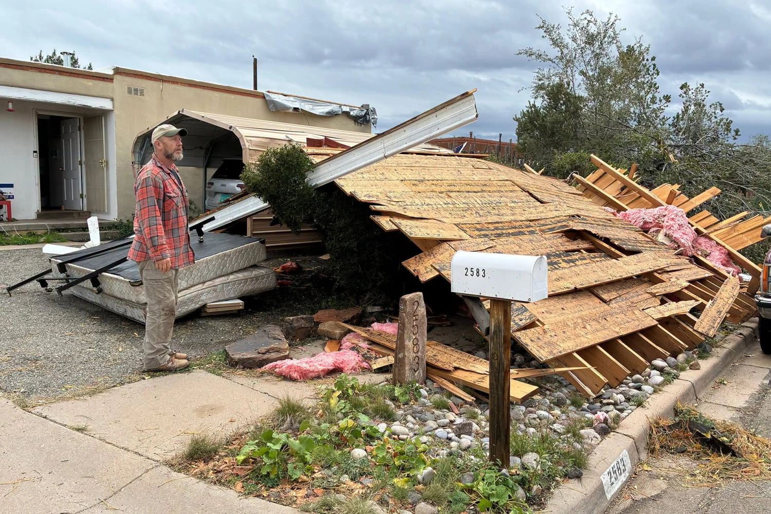Workers and residents clean up damage after a tornado hit Santa Fe, N.M., on Oct. 25, 2026.
