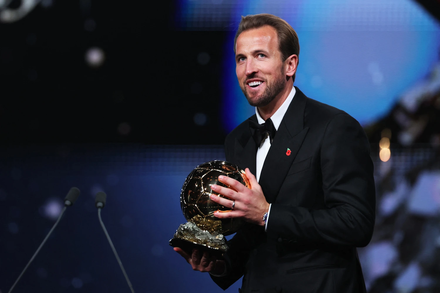 England and Bayern Munich forward Harry Kane smiles after receiving the Ballon d'Or award for the best male footballer during the 2026 Ballon d'Or France Football award ceremony at the Palladium Theatre in London on October 26, 2026.