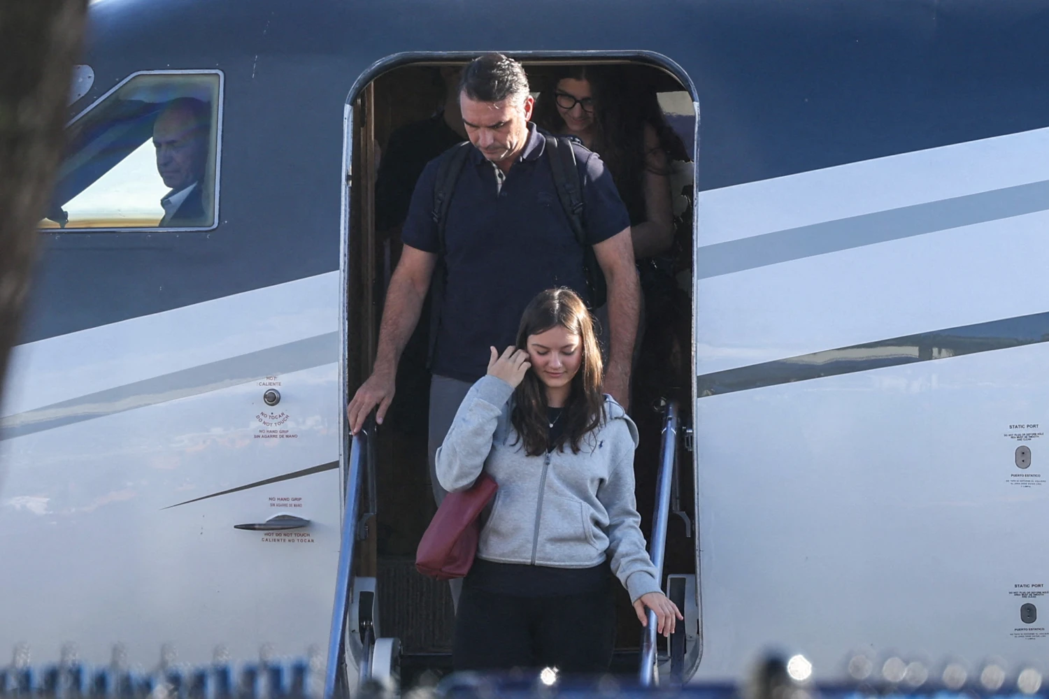 Flávio Bolsonaro steps off a plane with his family after arriving at Opa Locka Executive Airport in Miami on Wednesday.