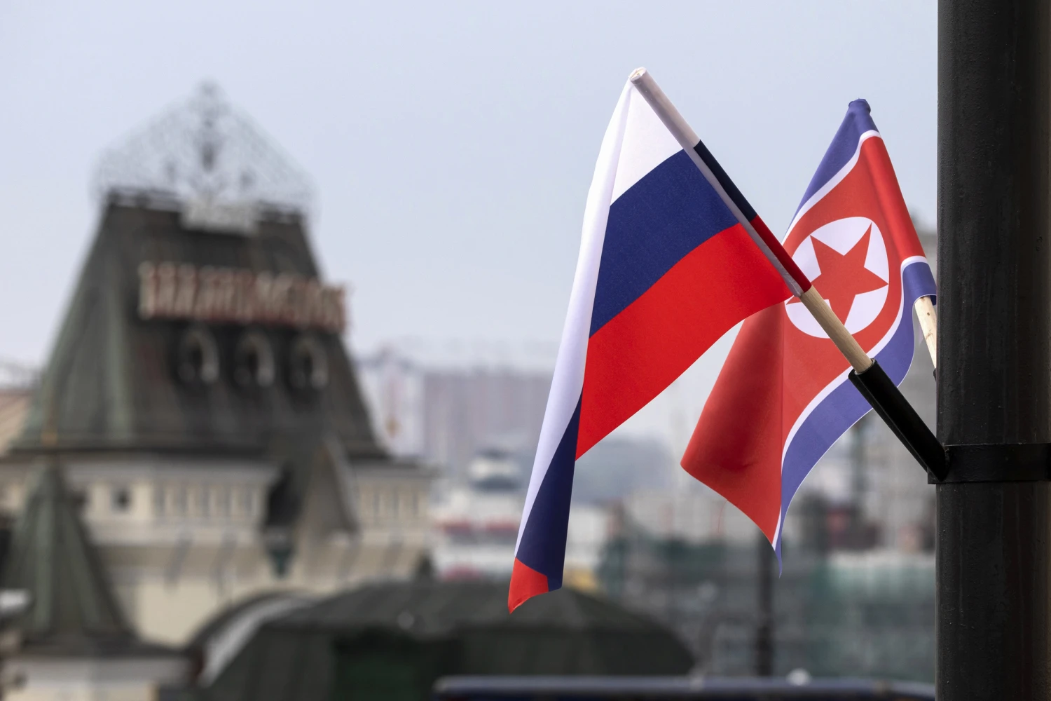 Flags of Russia and North Korea are seen in front of the central railway station in Vladivostok, Russia, Wednesday, April 24, 2019.