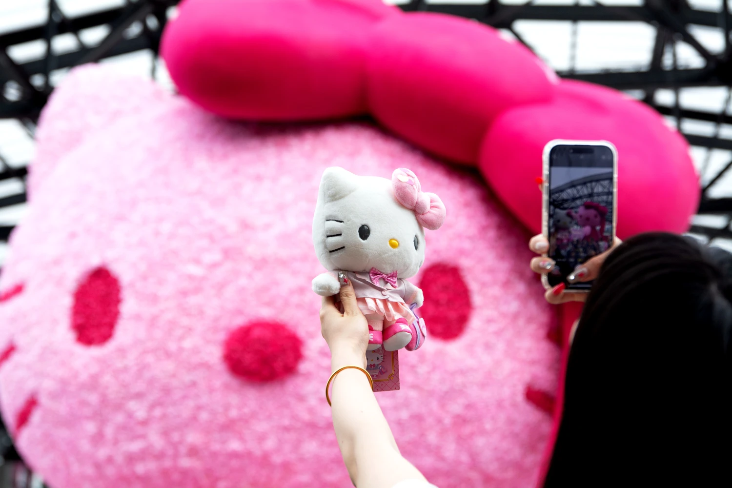People visit the giant Hello Kitty at West Bund in Shanghai, China, on April 19, 2025