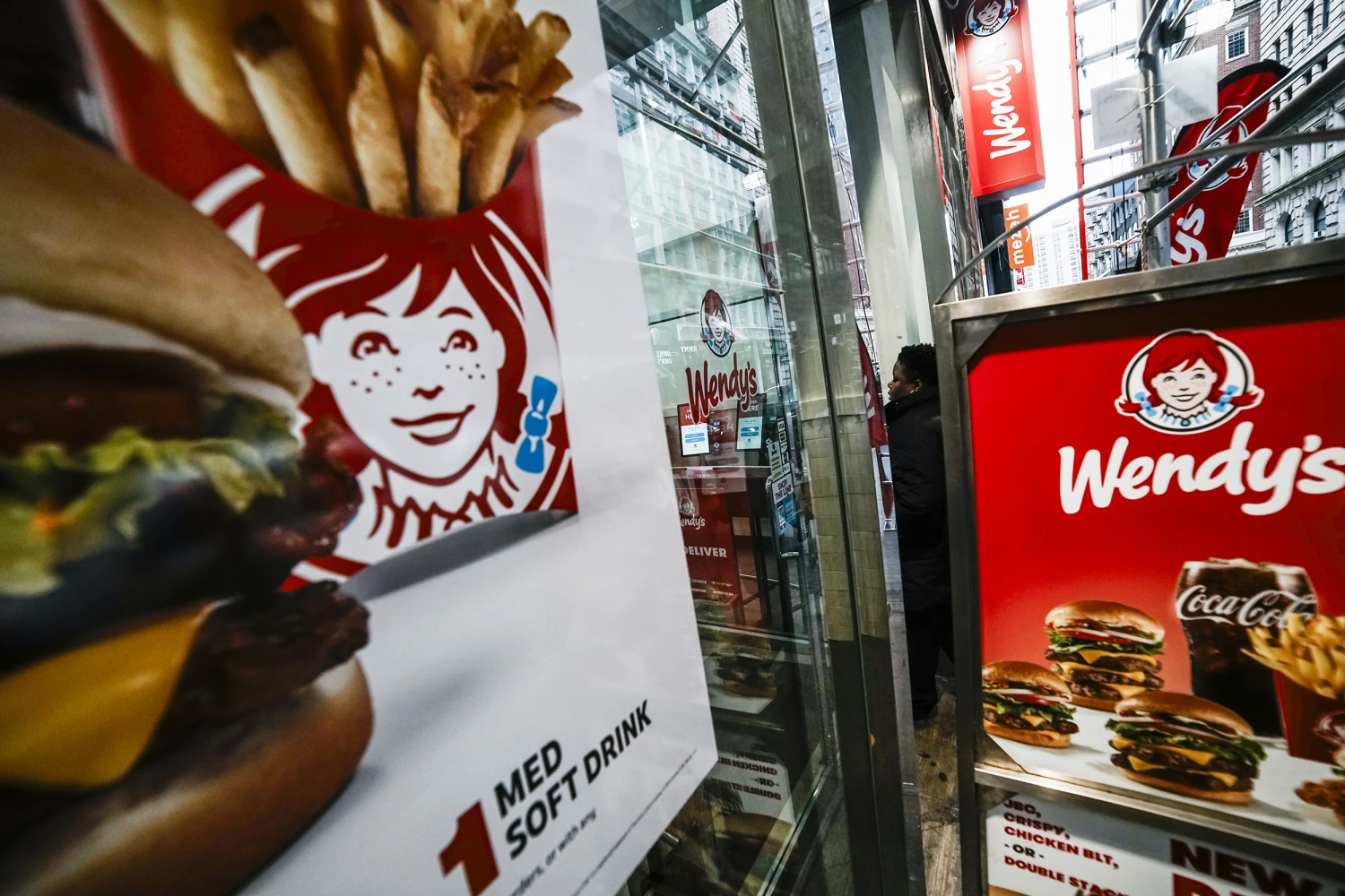 A customer goes into one of the Wendy's restaurants on November 13, 2025 in lower Manhattan, New York City. Fast food chain Wendy's has reported a 4.7% decline in sales at U.S. locations, and the company has decided to close hundreds of its U.S. stores next year.