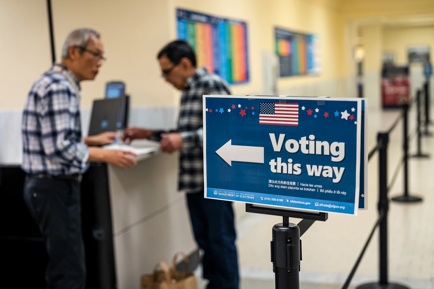 An election worker helps a voter with their ballot during early voting ahead of the midterm election at a polling location inside City Hall in San Francisco on Oct. 21, 2026.